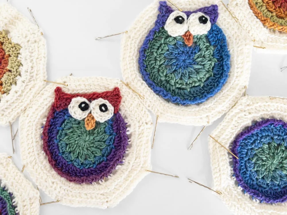 Handmade ganny square motifs including colorful crocheted owls.