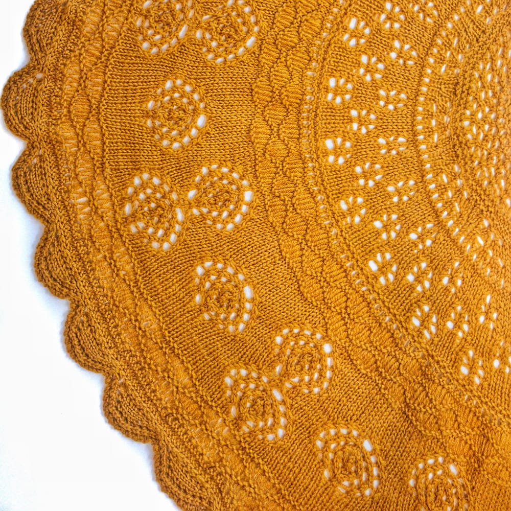 Golden mustard knit lace with intricate circular patterns, delicate eyelets, and a scalloped edge